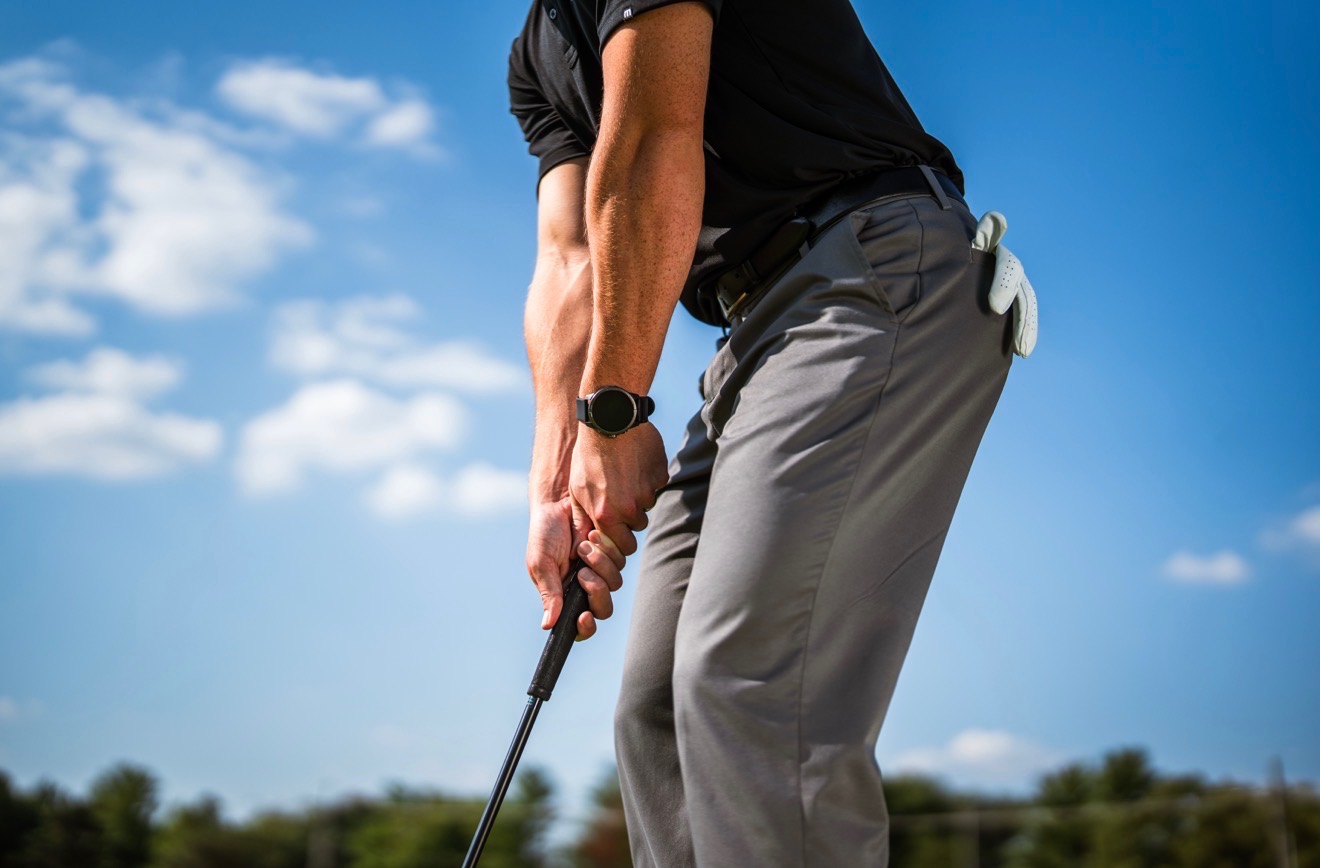Golfer wearing Garmin Tactix 9 Pro on the course